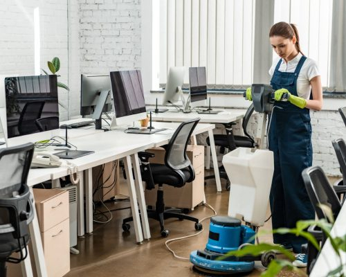 young-cleaner-washing-floor-in-open-space-office